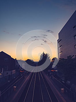 Sunset seen from a bridge at a train station