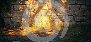 Sunset shadows on stone wall, garden ground