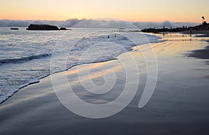 Sunset on shoreline below Heisler Park in Laguna Beach, California