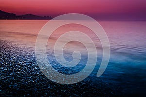 Sunset Shoreline Covered With Pebblestones