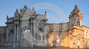 Sunset shot of closed gate leading former Ottoman Dolmabahce Palace, suited Ciragan Street, Besiktas distric. Gate contains -