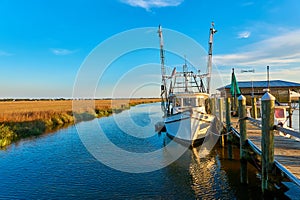 Sunset with shrimp boat along a dock at Tybee Island, Ga