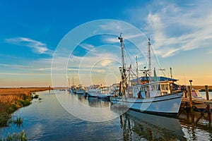 Sunset with shrimp boats along a dock at Tybee Island, Ga