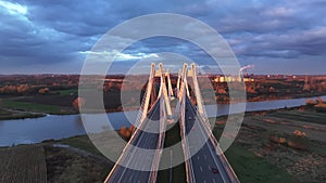 Sunset Silhouette of Cable-Stayed Bridge, Striking silhouette of a modern bridge against the sunset sky with industrial