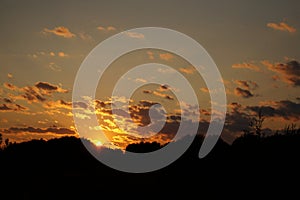 Sunset silhouette of church cross at sunset.
