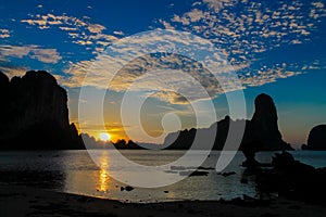 Sunset silhouette of cliff in sea Rail ey bay in Thailand