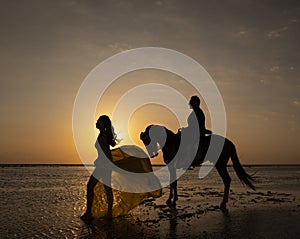 Sunset silhouette of a couple on Gili Trawangan island, Indonesia