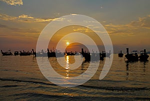 Sunset silhouette of fishing boat in sea bay in Thailand