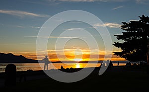 Sunset. Silhouette. People. Lake. Evening. Sky