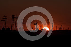 Sunset Silhouette of Transmission Towers and Railway Signals