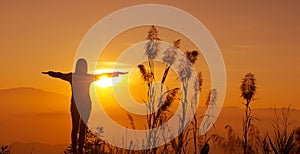 Sunset silhouette Young woman feeling to Freedom and Relax