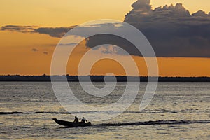 Sunset and silhouettes on boat cruising the Amazon River, Brazil