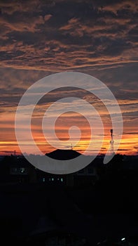 Sunset with silhouettes of buildings and towers