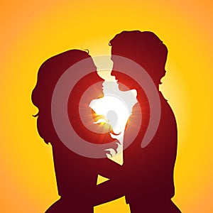 Sunset silhouettes of kissing couple