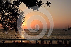 Sunset silhouettes at Nai Harn beach. Phuket. Thailand