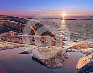 Sunset on skerries in Ytre Hvaler National Park, on the island of Kirkeoy in Norway