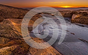 Sunset on skerries in Ytre Hvaler National Park, on the island of Kirkeoy in Norway