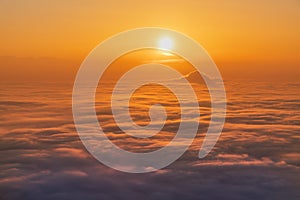 Sunset sky above clouds, dramatic sunset sky. Nature background, aerial view.