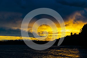 Sunset sky background. Dramatic gold sunset sky with evening sky clouds over the sea. Stunning sky clouds in the sunset. Sky lands