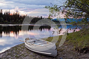 Sunset sky and canoe at Teslin River Yukon Canada