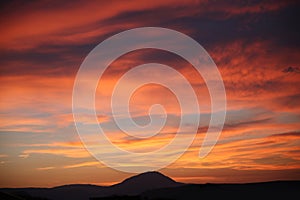 Sunset. Sky clouds background. Ridge Mountains silhouette. Skyline. Montenegro