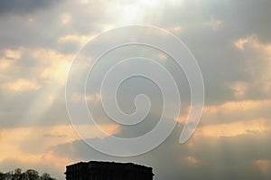 Sunset sky with clouds, light rays and other atmospheric effect. Golden clouds in dramatic light at sunset