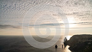 Sunset Sky Clouds Timelapse. A red burning sunset over the sea rocky volcanic cliff. Abstract nature summer ocean sea