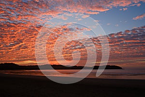 Sunset sky with colorful clouds over ocean at beach -