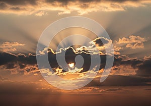 Sunset sky with dramatic clouds illuminated by the setting sun.
