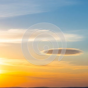 Sunset sky with a lenticular cloud,