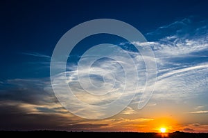 Sunset sky with multicolor clouds. Dramatic twilight sky background