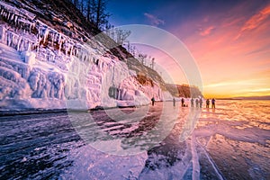Sunset sky with natural breaking ice over frozen water on Lake Baikal, Siberia, Russia
