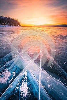 Sunset sky with natural breaking ice over frozen water on Lake Baikal, Siberia, Russia