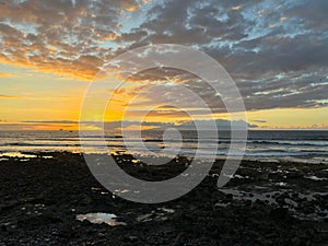 Sunset sky, the ocean and the coast of Playa de Las Americas, Tenerife, Canary Islands, Spain