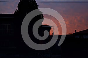 Sunset sky over a dark street of a rural town in winter