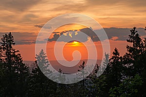 Sunset sky over a hilly forest