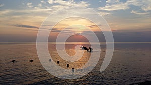 Sunset sky over the sea in the evening with colorful sunlight in the summer season, majestic sky. Horse walk in the water silhouet