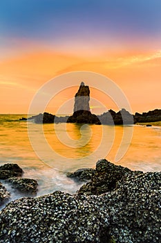 Sunset sky over seacoast rock on the beach