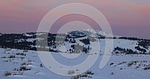 Sunset sky over the winter landscape with snow covered mountains and beautiful sunlight