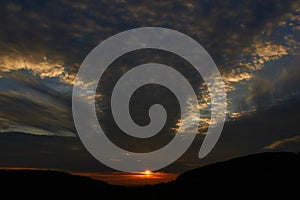 Sunset sky with punch hole clouds