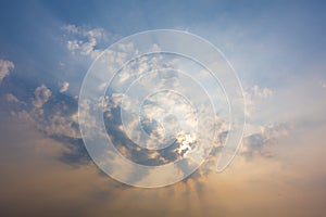 sunset sky with rays of light shining down pass clouds and sky