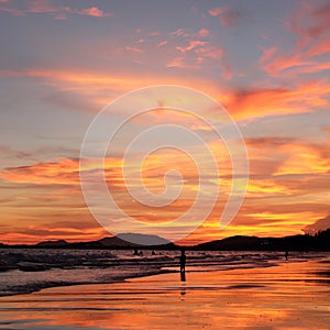 Sunset sky reflected on sea beach in summer time