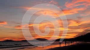 Sunset sky reflected on sea beach in summer time