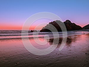 Sunset sky reflections on the beach at Pacific Coast