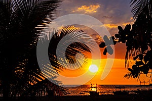 Sunset sky and sea landscape with wooden boats. Romantic seascape on tropical island. Orange sunset sky banner template