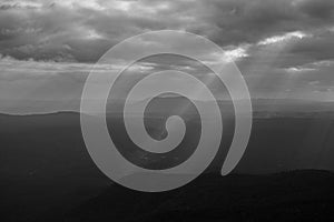 Sunset sky wide mountain landscape with ray of light at Pha Yieb Mek in Phu Kradueng National park. Thailand. Black and white