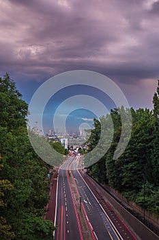 Sunset skyline of central London with storm clouds from Holloway Bridge, UK photo