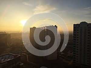 Sunset among skyscrapers. Beautiful house is illuminated by sunlight. Details and close-up.