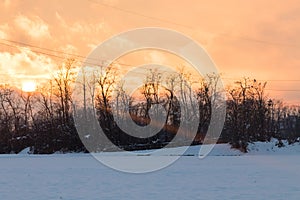 Sunset on a snowy countryside in winter time