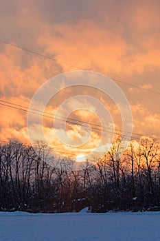 Sunset on a snowy countryside in winter time